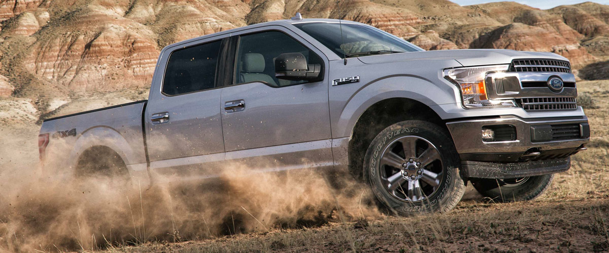 Silver Ford F-150 on dirt road