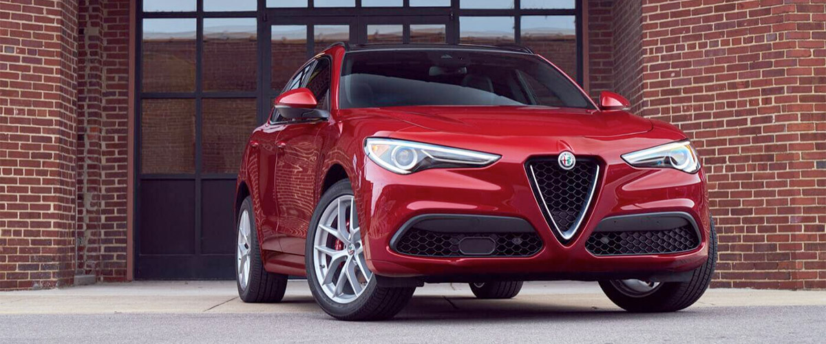 2020 Alfa Romeo Stelvio parked in front of a brick building