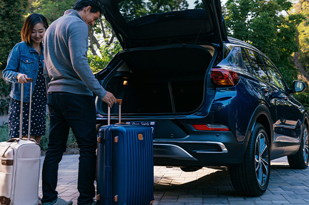 Loading up back of Buick Encore GX with suitcases