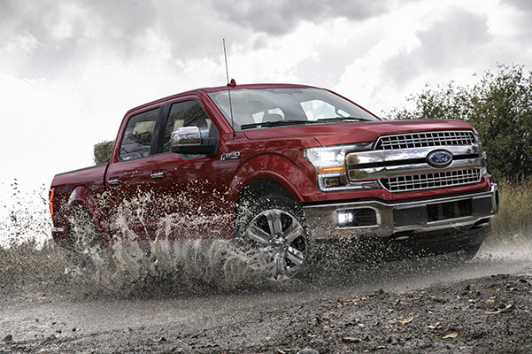 ref Ford F-150 pick up truck going through water and mud