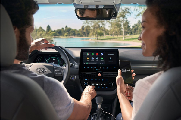 Passenger inside a 2021 Hyundai Ioniq Hybrid connecting her smart phone to the touch screen
