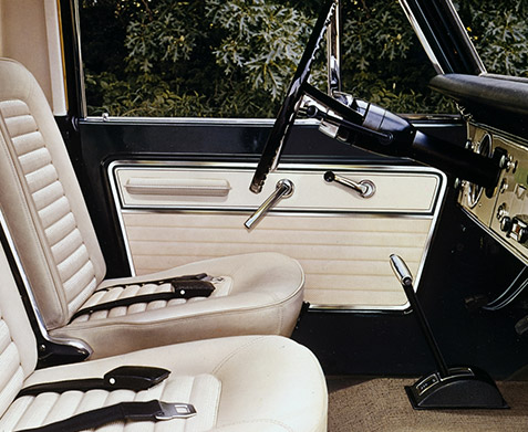  A 1967 Ford Bronco Sport interior with Parchment Vinyl driver and passenger bucket seats.