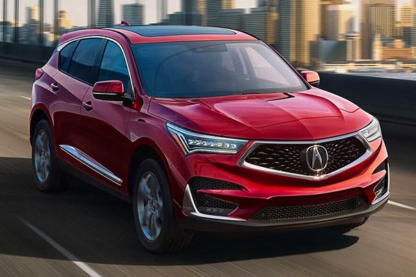 2021 Acura MDX driving over bridge with city in background