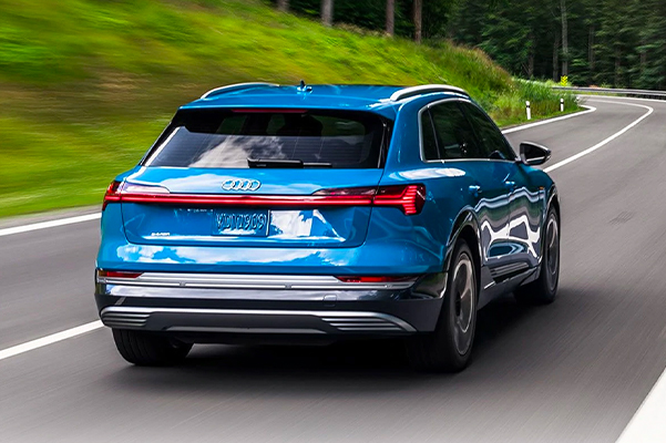 Rear-view of the Audi e-tron® carving a corner.