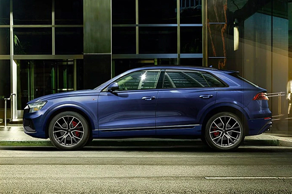 Side profile of the Audi Q8 parked.