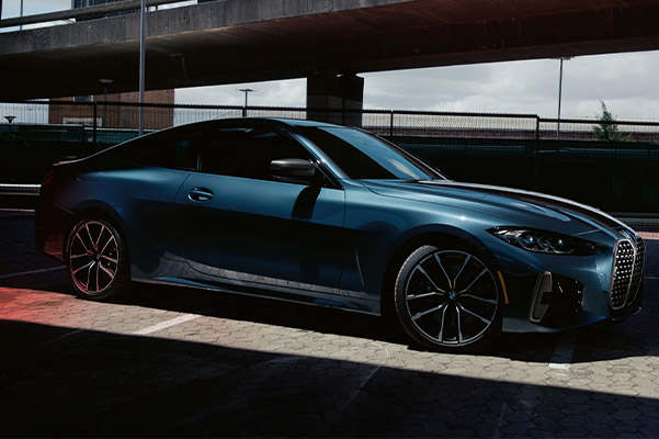 side view of BMW 4 series couple located under a bridge