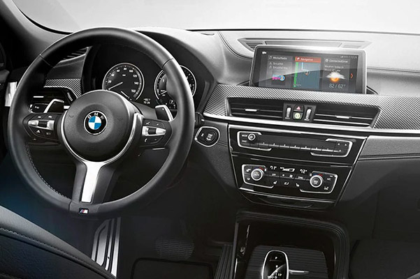 Interior view of the BMW X2 cockpit showing M steering wheel and driver controls