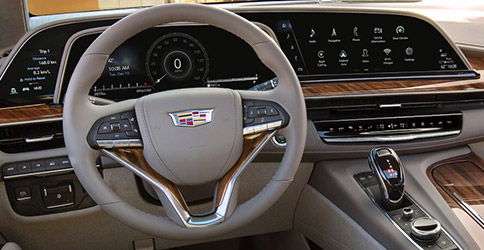 interior view of 2021 cadillac escalade suv featuring drivers dashboard and digital screen