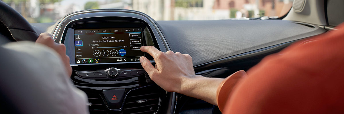 Lady using center screen on dashboard