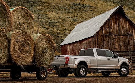 2021 Ford Super Duty towing bales of hay at farm