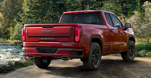 Rear shot of the 2021 GMC Sierra 1500 parked by a river