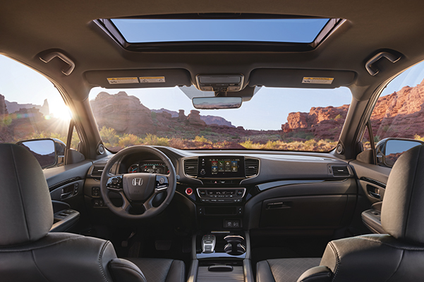 Interior view of the 2021 Honda Passport Elite with Black Leather showing the major instrument panel, featuring Apple CarPlay® integration on the Display Audio touch-screen.