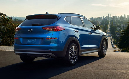 2021 Hyundai Tucson rear view heading to a road with trees around it