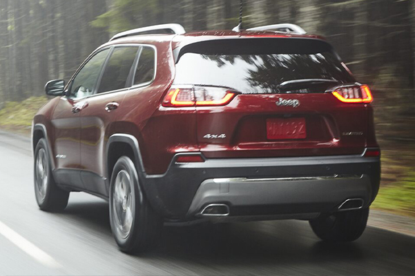 A 2021 Jeep Cherokee being driven on an open road.