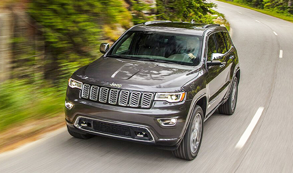 The 2021 Jeep Grand Cherokee Limited being driven around a bend in the road.