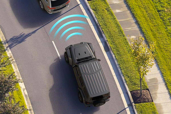 Illustration of sensors monitoring the area in front of the 2021 Jeep Wrangler, detecting the vehicle ahead, that it's approaching.