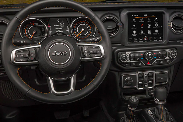 The interior of the 2021 Jeep Gladiator Overland, focusing on the steering wheel and instrument panel.
