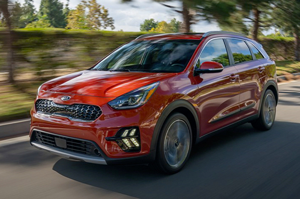 red 2021 Kia Niro driving down the road