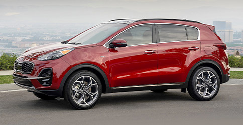 2021 red kia sportage parked on the road