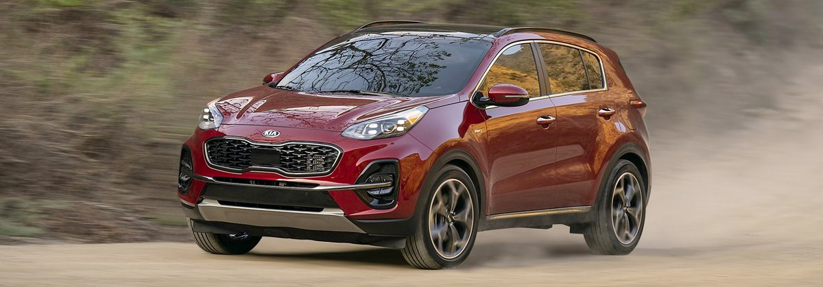 Kia Sportage on dirt road.