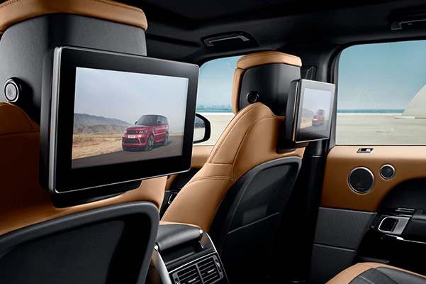 Interior shot of the back seat in a 2021 Range Rover Sport with flatscreens mounted on the back of the font seats
