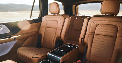 The Second row of a 2021 Lincoln Aviator is shown with the optional center console positioned between the two captains chairs