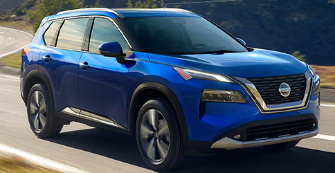 Blue Nissan Rogue driving in the mountains