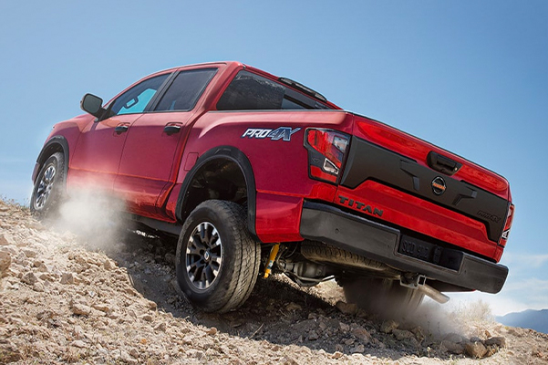 2021 Nissan Titan PRO-4X in red climbing a large rock pile