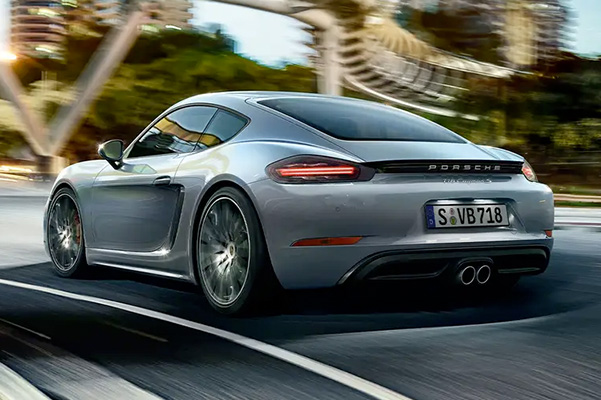 rear view of a 2022 Porsche 718 Cayman driving down the road
