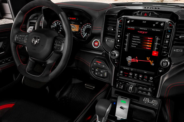 Display A interior shot from the perspective of the front passenger seat showing the 12-inch touchscreen in the 2021 Ram 1500 TRX with the Drive Mode page open.