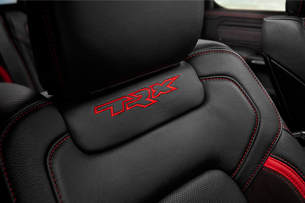 Display A close-up shot of the embroidered TRX logo on the front passenger seatback in the 2021 Ram 1500 TRX.
