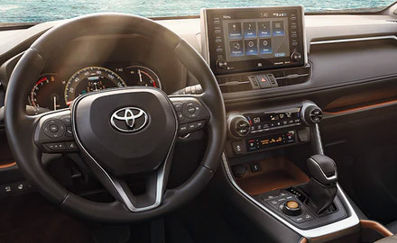 interior detail shot of 2021 toyota rav4 hybrid showcasing driver's dashboard and digita screen