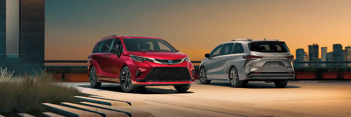 two new 2021 Toyota Siennas parked in front of a city skyline