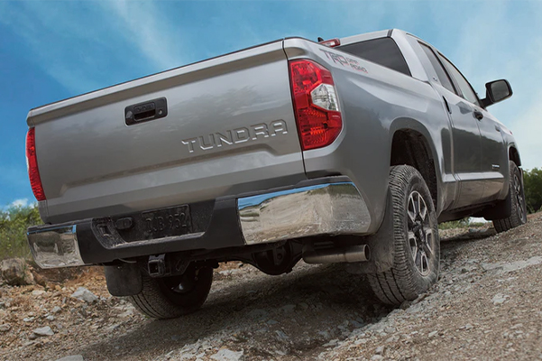 rear view of Toyota Tundra going up hill on a tough mountain terrain 