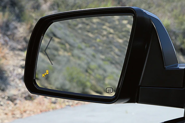 close up of Toyota Tundra's side mirror showcasing bling spot yellow icon activated