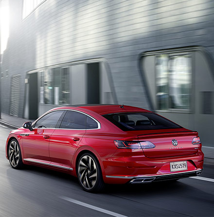 Red 2021 Volkswagen Arteon Rear view driving on road
