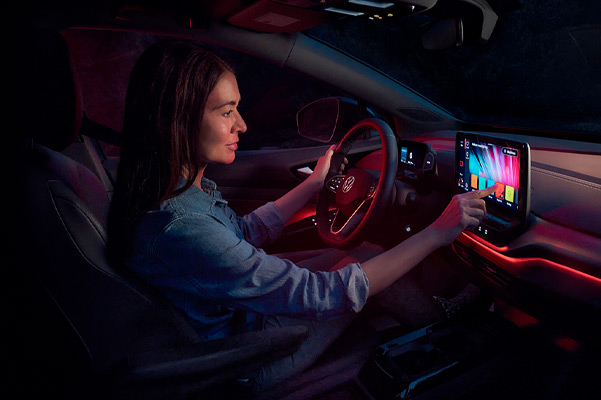 A woman adjusts the ambient lighting inside an ID.4.