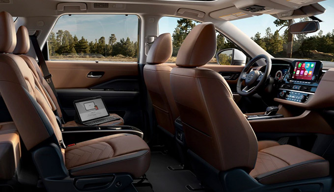 side profile interior view of 2022 nissan pathfinder showcasing leather seats and driver dashboard with digital screen