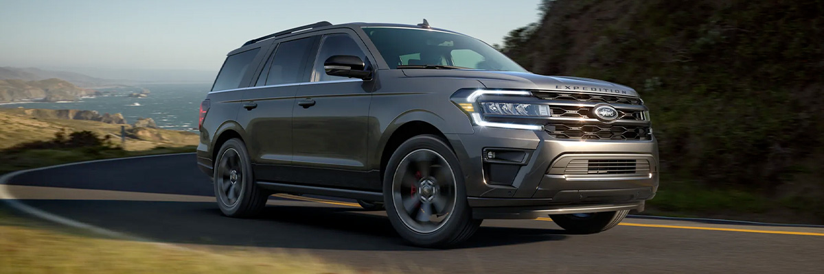 2022 Ford Expedition Stealth Performance Edition in Dark Matter Metallic Pearl Coat being driven on a curving road