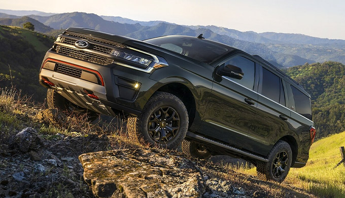 2022 Ford Expedition Timberline in Forged Green Metallic being driven up a mountain road