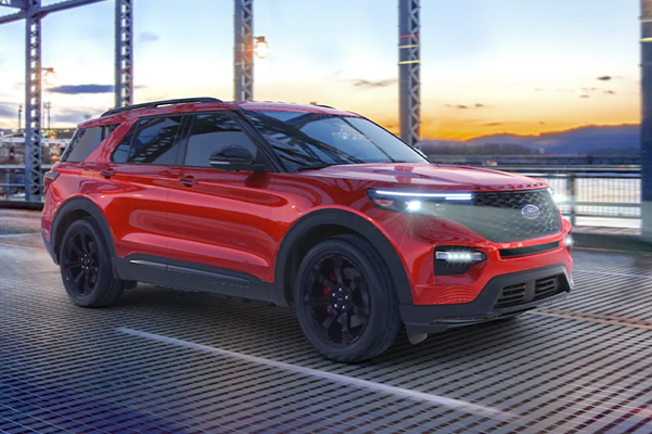 red 2022 Ford Explorer driving over a metal bridge