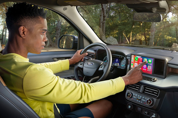 Man using dashboard touch screen in driver seat