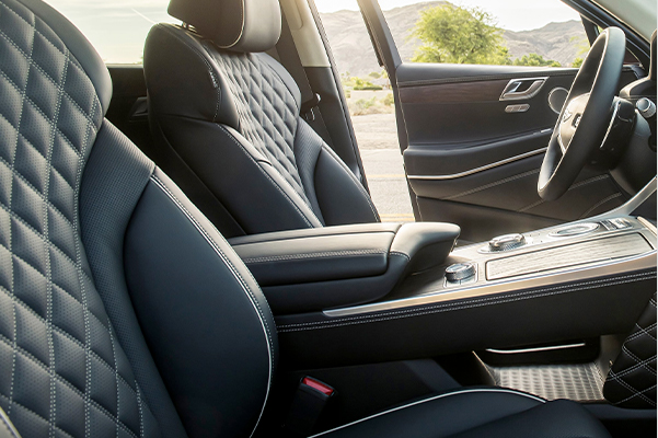 Interior shot of the 2022 Genesis GV80 seating with the door open on a sunny day