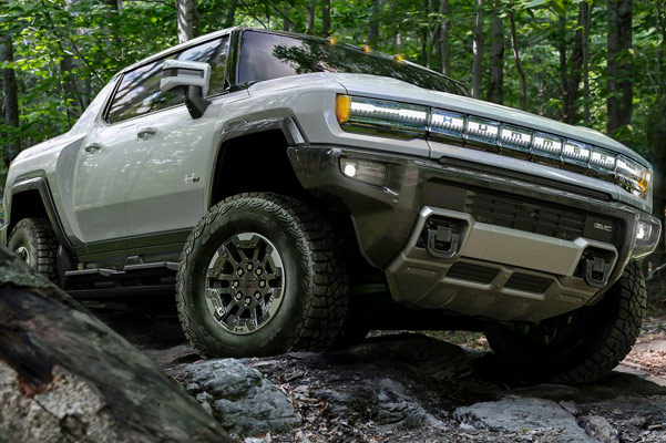 hummer EV parked on the forrest