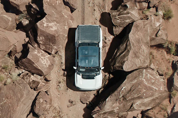 2022 HUMMER EV navigating through rocky mountains