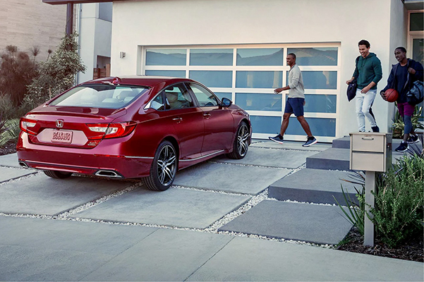 red 2022 honda accord parked in front of a house garage