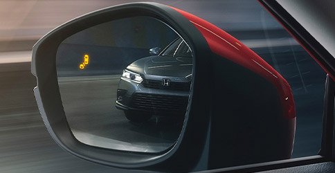 Detail view of driver-side mirror with blind spot information indicator in the 2022 Honda Civic Touring Sedan.