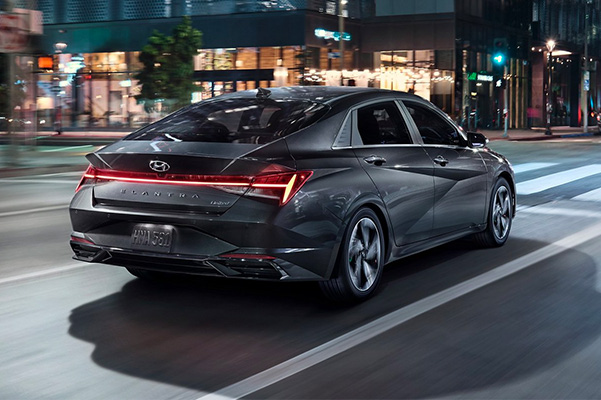 2022 Hyundai Elantra driving down street at night in city