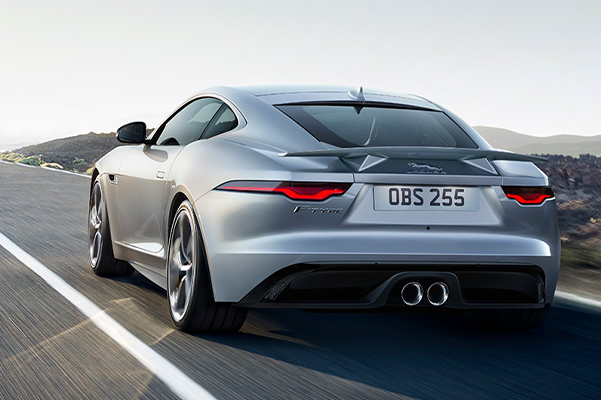 rear shot of F-TYPE driving on road with moutains in background