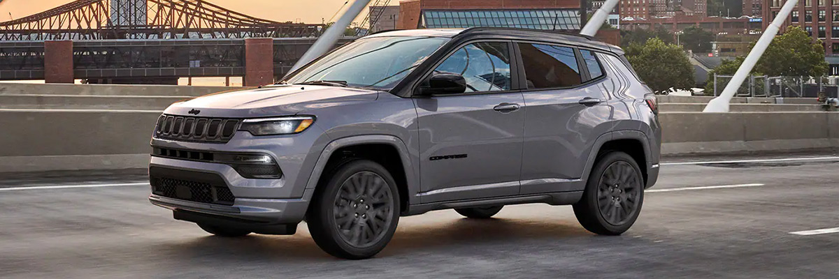 The 2022 Jeep Compass High Altitude parked on a bridge overlooking a city.